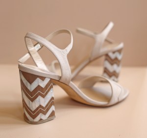 Fratelli Rossetti presented a limited edition sandal developed in partnership with Lebanese designer Nada Debs. Dubbed “Design at your heels,” the style features a zig-zag pattern on the heel made of walnut wood with mother-of-pearl inlay. According to Debs, the motif symbolizes the heartbeat of Milan and Beirut, which she considers two buzzing cities and creative hubs. “I met Nada on one of my travels to Beirut, a city that I love for its intellectual vivaciousness” said Diego Rossetti, president of the footwear brand. “I visited her studio and I was fascinated by her ability to combine design and craft, which are values that we share.” The style, which was offered in off-white and red versions, was produced in only sixty pieces. Retailing at 550 euros, the limited-edition sandal is available exclusively at the brand’s Milan and Beirut stores, in addition to Fratelli Rossetti’s e-commerce.