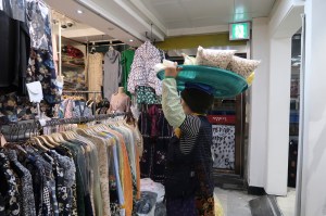 A woman sells snacks to stall operators at Dongdaemun.