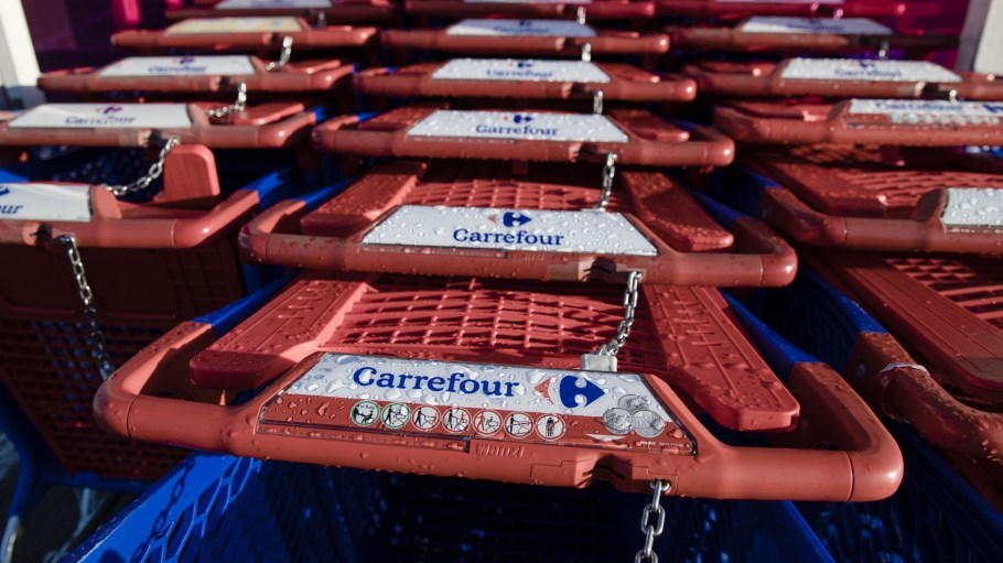 Locked shopping carts stand in a customer collection bay outside a Carrefour SA supermarket in the Rosny-sous-bois district of Paris, France.