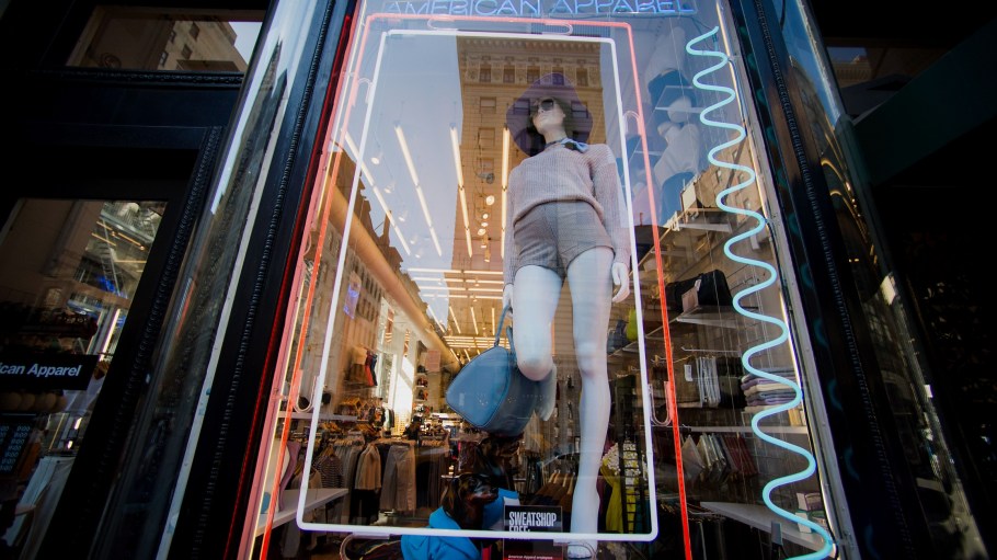 A mannequin stands in the window of an American Apparel Inc. store in New York, U.S.