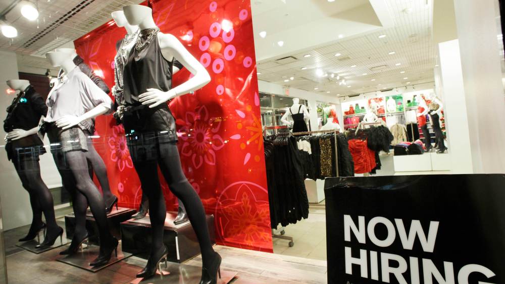 A "now hiring" sign is shown in the window of an Express clothing store, in New York. Slightly more people applied for unemployment benefits last week, but first-time claims remain near their lowest level in two yearsEconomy Unemployment, New York, USA