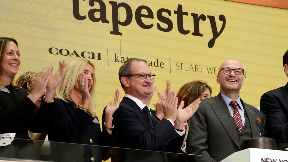 Tapestry Inc. CEO Victor Luis, right, home to Coach, Kate Spade and Stuart Weitzman brands, is applauded as he rings the New York Stock Exchange opening bellFinancial Markets Wall Street, New York, USA - 31 Oct 2017