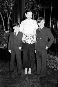 Vanderbilt siblings Carter and Anderson Cooper wearing suits and ties at their mother Gloria Vanderbilt's fashion show in 1978.
