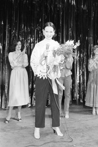 Outtake; Gloria Vanderbilt with flowers at her fashion show in 1970..Article title: "Gloria Vanderbilt: Making (air) waves"