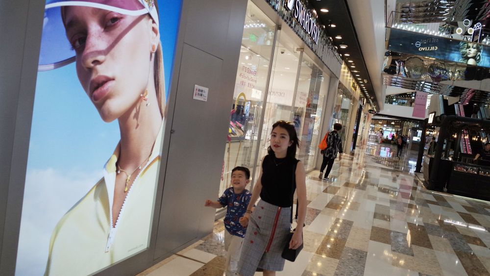 Chinese consumers walk at a shopping mall in Beijing, China, 28 May 2019. According to media reports, middle-class citizens are expressing their concerns over how the China-US trade war will affect their lives as food prices and business costs continue to rise.China-US trade war affects middle class in China, Beijing - 28 May 2019