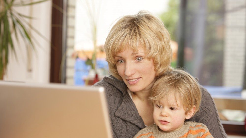 MODEL RELEASED Blonde mother with 2 year old son at the laptopVARIOUS