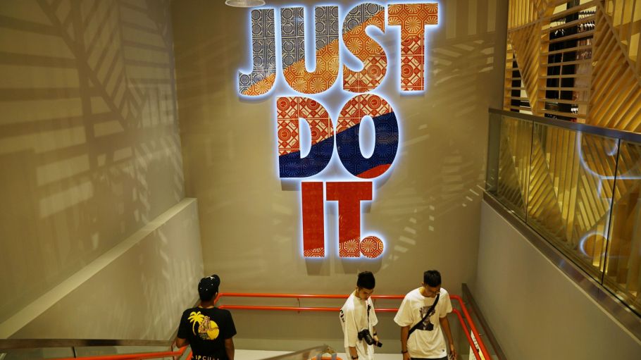 Shoppers walk down the stairs in a Nike store in Jewel Changi Airport in Singapore, on Thursday, April 11, 2019.