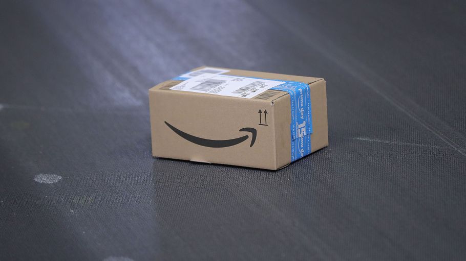 The Amazon.com Inc. logo sits on a sealed box on a conveyor inside an Amazon.com Inc. fulfilment center during the online retailer's Prime Day sales promotion day in Koblenz, Germany, on Monday, July 15, 2019.