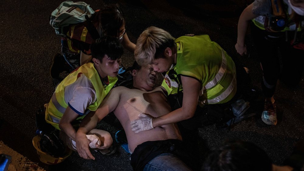 Paramedics attend to an injured man from Sunday's protest.