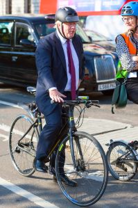 Boris Johnson cycling around Parliament Square on his way to the House of Commons
