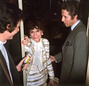 French fashion designer Coco Chanel (C) is congratulated by French principal dancer Jacques Chazot (R) after presenting her Spring-Summer collection in Paris 30 January 1958. (Photo credit should read STF/AFP via Getty Images)