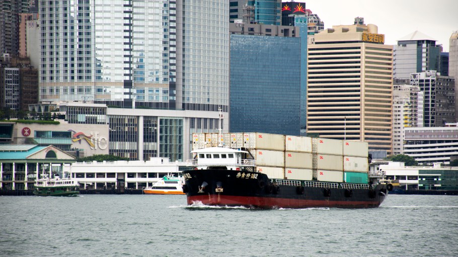 Cargo Ship in sea of Victoria Harbour between kowloon and Hong Kong island sailing go to ocean while raining storm on September 10, 2018 in Hong Kong, Mainland China