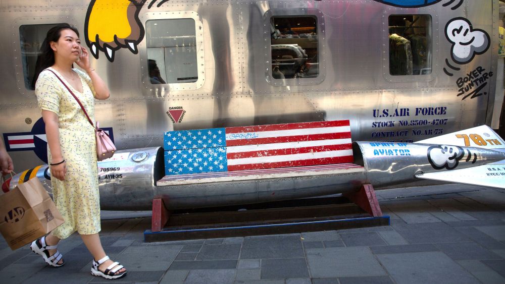 A woman walks past a bench shaped like a missile painted with the U.S. flag outside of a clothing store at a shopping mall in Beijing, . President Donald Trump and Chinese President Xi Jinping agreed to a new cease-fire Saturday in a yearlong trade war during their meeting on the sidelines of a conference in Japan, averting, at least for now, an escalation feared by financial markets and the business community while negotiations continueTrump, Beijing, China - 29 Jun 2019