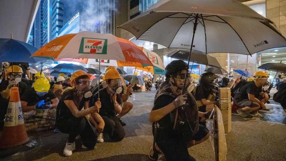 Demonstrators use umbrellas and home made shields to protect themselves from police rubber bullets firing against them during the anti-government protest. Protests in Hong Kong, China