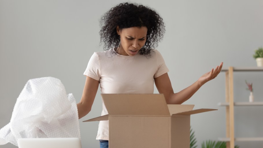 Disappointed shocked frustrated woman customer opening package displeased with online order may return