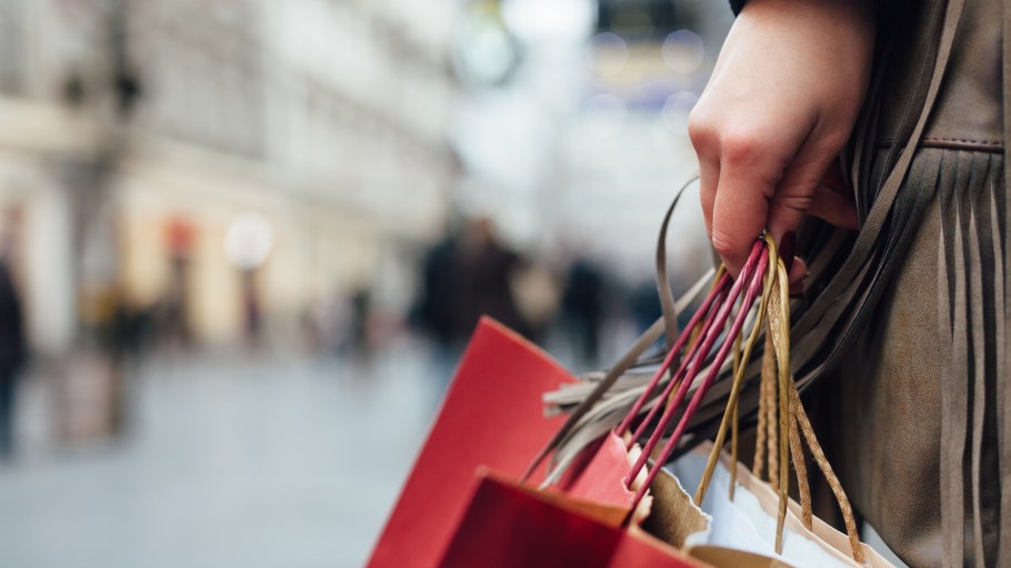 Close up of shopper holding shopping bags
