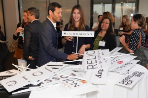 Guests posed with signs from their respective companies.