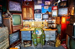 A tinker shop with old TVs and radios.
