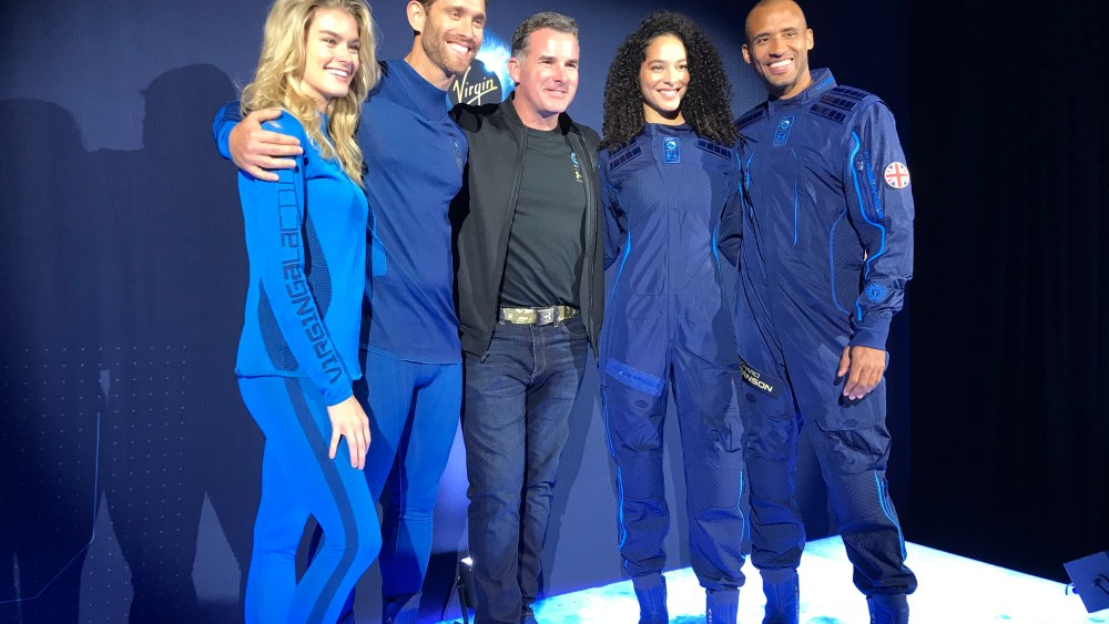 Under Armour's Kevin Plank with models in the Virgin Galactic space gear.