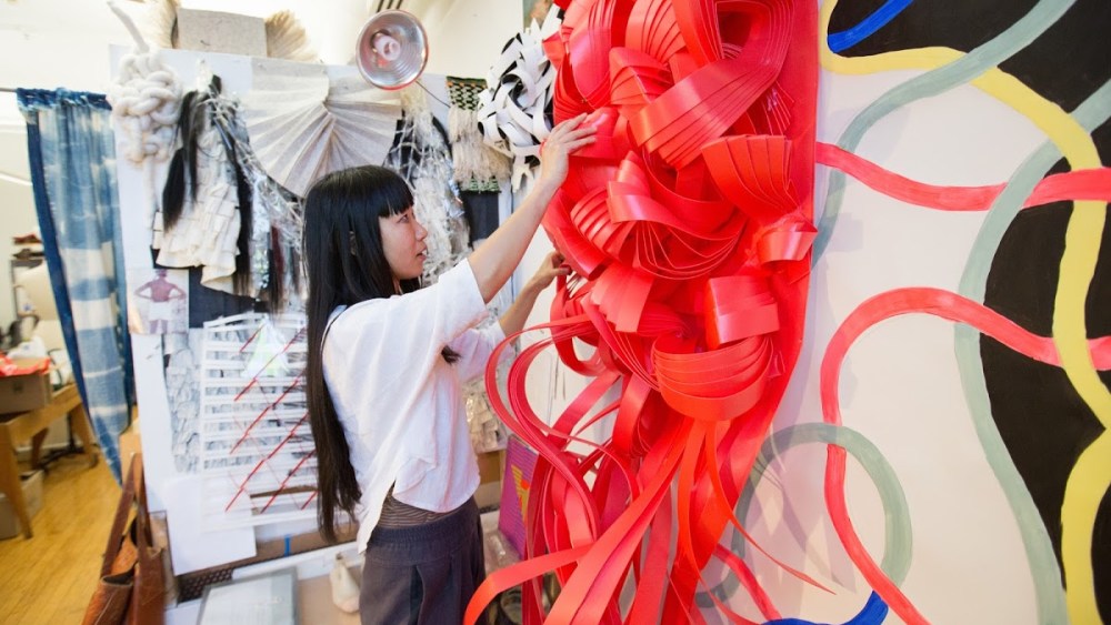 A RISD student works with textiles.