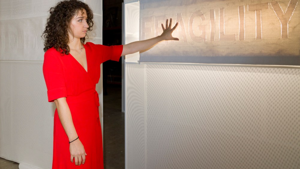 Chlo Bensahel with her tapestry, which emits lights and sounds when touched