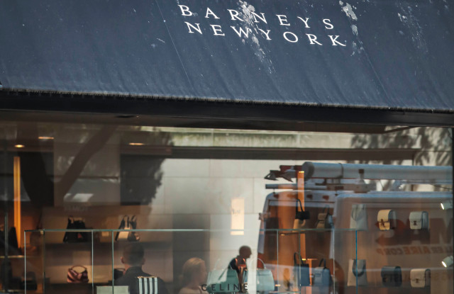 A pedestrian reflect in a store window at Barneys department store, in New York. The luxury retailer could be joining a growing list of retailers that have filed for bankruptcyBarneys -Options, New York, USA - 16 Jul 2019