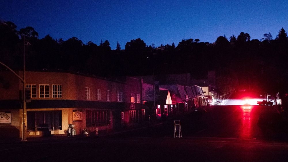 A car drives through a darkened Montclair Village as Pacific Gas & Electric power shutdowns continue in Oakland, Calif. The area remains without power after the utility cut service hoping to prevent wildfires during dry, windy conditionsCalifornia Power Outages, Oakland, USA - 10 Oct 2019