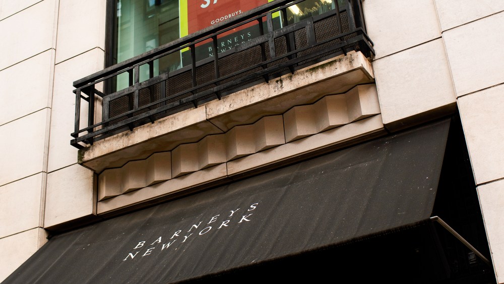 In the windows of the Madison Avenue Barneys New York flagship, signs blast 40 to 60 percent off.