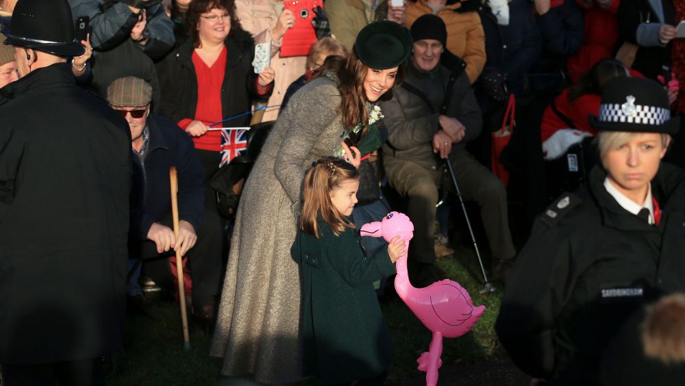 Britain's Catherine, Duchess of Cambridge, center left, speaks with her daughter Princess Charlotte as she holds a pink flamingo while greeting the public outside the St Mary Magdalene Church in Sandringham in Norfolk, EnglandRoyals Christmas, Sandringham, United Kingdom - 25 Dec 2019