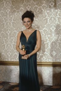 Joan Collins Actress Joan Collins poses while holding an award she received for best actress in a dramatic TV series "Dynasty" at the Golden Globe Awards, Los Angeles, CalifJoan Collins 1983, Los Angeles, USA