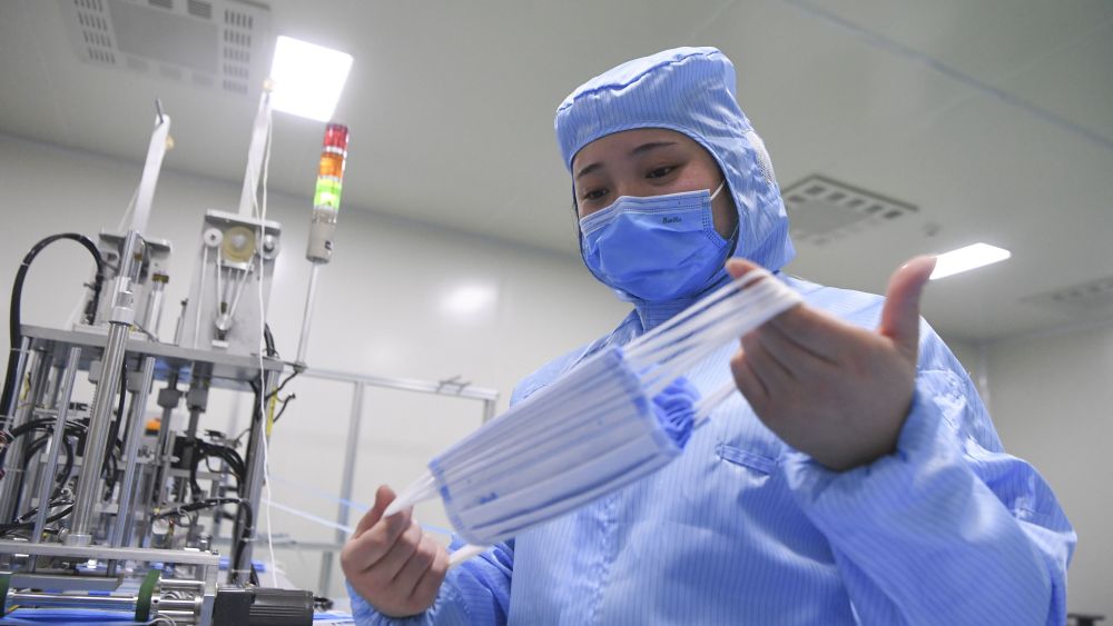 A staff member works at the producing workshop of face mask in a medical devices company in Nan'an District of southwest China's Chongqing