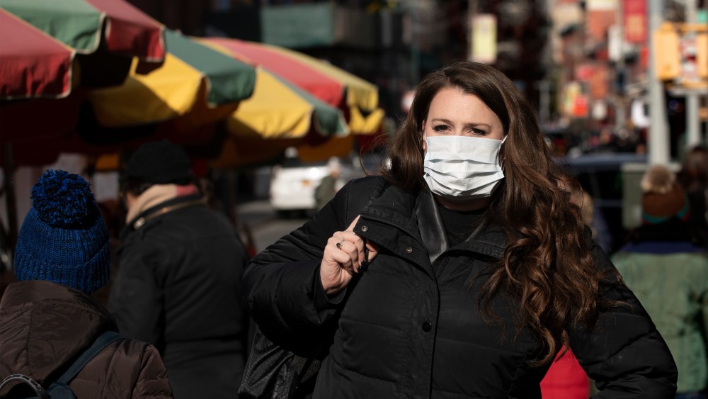 A woman, who declined to give her name, wears a mask, in New York. She works for a pharmaceutical company and said she wears the mask out of concern for the coronavirus. "I'd wear a mask if I were you," she said. For the first time in the U.S., the new virus from China has spread from one person to another, health officials said ThursdayChina Outbreak US, New York, USA - 30 Jan 2020