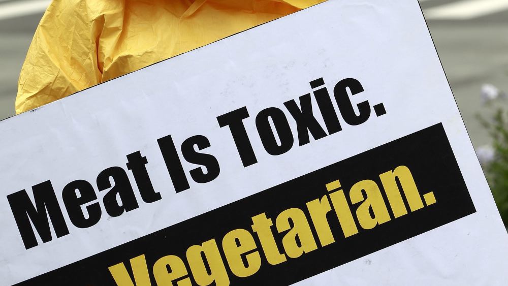 A Member of 'People For the Ethical Treatment of Animals' (peta) Protests Wearing a Yellow Hazardous Material Suit with a Gas Mask and Holds a Signs That Reads 'Meat is Toxic Go Vegetarian' on the Street in Seoul South Korea 24 August 2012 Korea, Republic of SeoulSouth Korea Peta Protest - Aug 2012