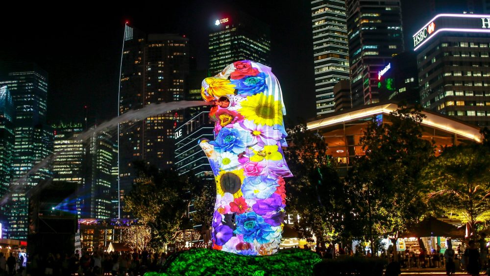 Pictured against the skyline of the financial district, a floral pattern is projected on facade of the Merlion statue as part of a projection display titled 'Elements of Life' during the i Light Marina Bay Festival in Singapore, 09 March 2018. The i Light Festival will run from 09 March till 01 April and features art work made from recyclable or sustainable materials.i Light Marina Bay Festival in Singapore - 09 Mar 2018