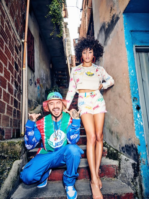 Guess x J Balvin Returns with Colorful Spring 2020 Collection (LW) Denim brand Guess and J Balvin teamed on a second capsule collection that reflects his Medellín hometown and upcoming album, Colores. Guess and global music superstar J Balvin teamed on a second capsule collection. This time, it’s packed with color and personality that reflects both the singer’s hometown of Medellín, Colombia, and his upcoming album. After the widespread success of their first collaboration, Guess and Balvin were inspired to go back to the drawing board and provide even more offerings. The Guess x J Balvin Colores Spring 2020 collection is available for men, women and children, and captures all of the vibrant colors of Medellín. The collection infuses bright red, yellow, green, blue and purple tones into each piece. Standout looks include a women’s matching white denim set with a cropped denim jacket and high waisted denim shorts covered in colorful logos. The same print is seen in a men’s version of the matching women’s set, featuring a denim trucker jacket and jeans. The collection also includes a long-sleeved T-shirt with tie dye elements and a matching bucket hat emblazoned with the Guess logo. “What initially started as a collection has turned into year-round energy,” Guess’ director of brand partnerships Nicolai Marciano said in a statement. “We organically elevated the partnership to wardrobe his whole tour and dancers, large festival merchandise moments, amongst other one-offs opportunities. With this new collection, Colores, we really pushed ourselves collectively and we’re excited to unveil our most robust collection for men, women and kids. Balvin’s passion and commitment as a partner is the ideal space to create within.” Shot in Medellín, the campaign features Balvin and models Jamea Byrd and Sara Orrego. The shoot was directed by Marciano, styled by DJ and model Sita Abellan and photographed by Tatiana Gerusova. Balvin, known as “reggaeton’s global ambassador,” made sure the collection reflects the mood of his upcoming album, “Colores,” dropping in March. In early 2019, Guess and Balvin collaborated on a “Vibras” collection named after his most recent album at the time. The campaign fell under scrutiny later that year when a mural artist sued Guess after claiming the brand used imagery of his Miami artwork without his permission. Shoppers can gain early access to the Guess x J Balvin Colores collection at popup experiences in Chicago, Los Angeles, Miami and New York, March 20- 22. The full Guess x J Balvin Colores collection will be available in Guess stores and on its website on March 27.