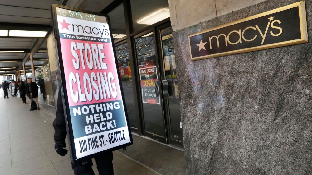 Raymond Martin walks with a "store closing" sign on his back in front of the Macy's store in downtown Seattle. The store is one of nearly 30 Macy's stores to be closed nationwide in the coming weeks Macys Closing, Seattle, USA - 09 Jan 2020