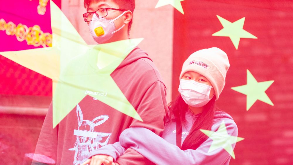 A double exposure picture shows a couple wearing masks in an attempt to protect themselves from a coronavirus contagion.