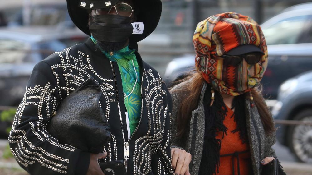 Guests wear face masks to protect against coronavirus upon arrival to attend the Dolce and Gabbana show during the Milan Fashion Week, Milan, Italy, 23 February 2020. The disease caused by the novel coronavirus (SARS-CoV-2) has been officially named COVID-19 by the World Health Organization (WHO). The outbreak, which originated in the Chinese city of Wuhan, has so far killed more than 2,000 people, with over 75,000 infected worldwide, mostly in China. The Fall-Winter 2020/2021 Women's collections are presented at the Milano Moda Donna from 18 to 24 February 2020.Dolce&Gabbana - Runway - Milan Fashion Week Women's FW 20/21, Italy - 23 Feb 2020