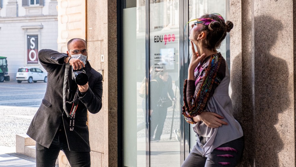 A photographer with a mask to protect himself from the COVID-19 coronavirus and a model take part in a fashion shootCoronavirus outbreak, Milan, Italy - 24 Feb 2020