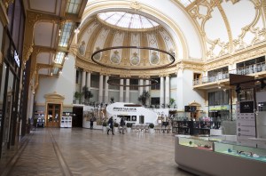 Two people walk with shopping bags in a nearly empty shopping mall in the center of Antwerp, Belgium, .