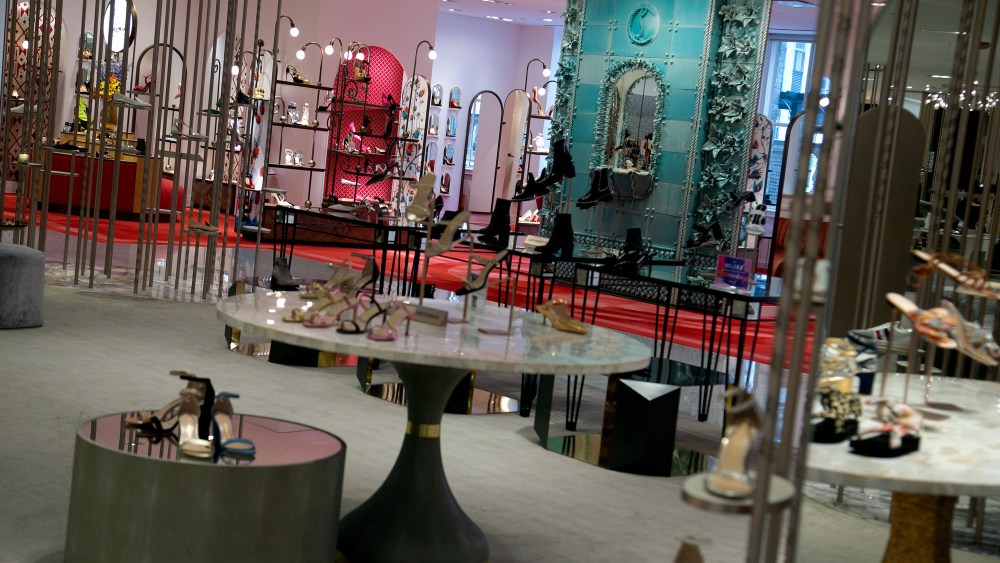 Christian Louboutin’s shop-in-shop features a ceramic fountain and aged brass vines.
