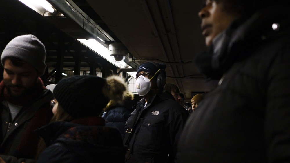 A man wears a mask while waiting for a subway in New York, New York, USA, 28 February 2020. Many people around the world are wearing masks in an effort to protect themselves from the coronavirus, though medical experts are advising that basic paper masks have a limited ability to protect people.People Wearing Masks in New York, USA - 28 Feb 2020