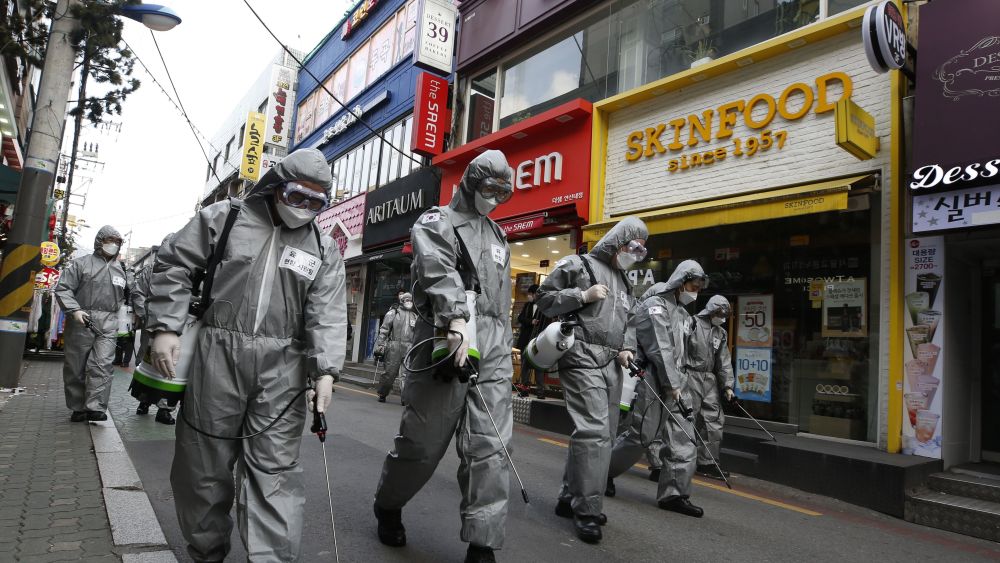 South Korean soldiers spray disinfectant in front of beauty stores Skinfood and Aritaum.