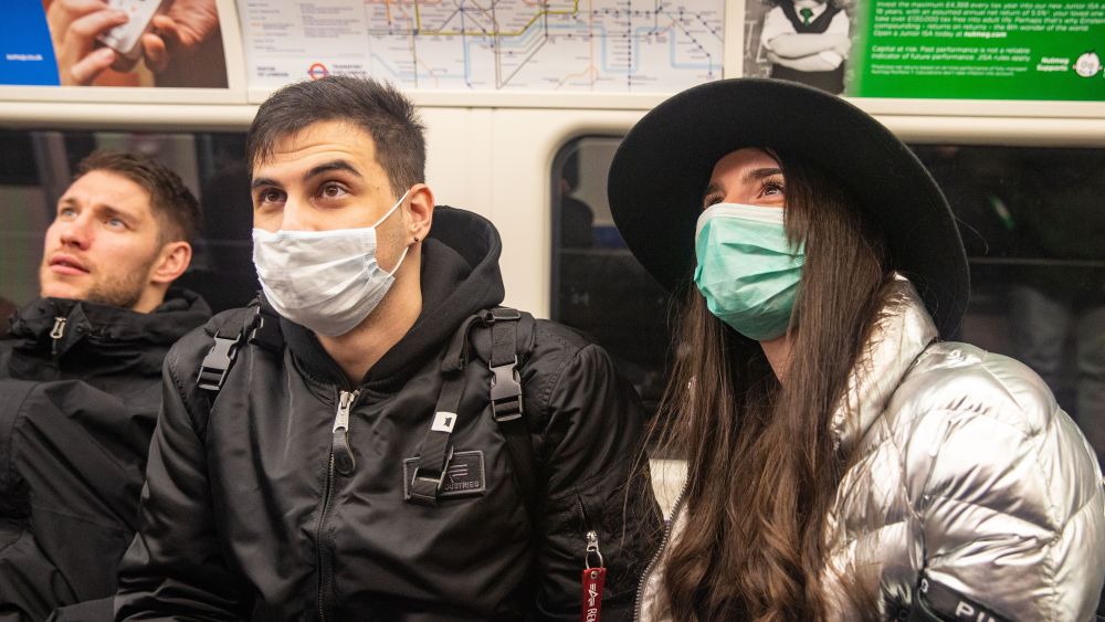 Two people wearing masks on the London Underground. Coronavirus cases across the world has today topped 100,000 and the Uk's Chief Scientific adviser has warned that it has now become a 'global epidemic'.Coronavirus -06 03 2020