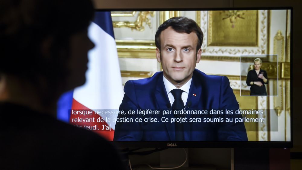 French President Emmanuel Macron is seen on a television screen as he speaks during a televised address to the nation on the outbreak of COVID-19French President Emmanuel Macron's address to the nation, Paris, France - 16 Mar 2020