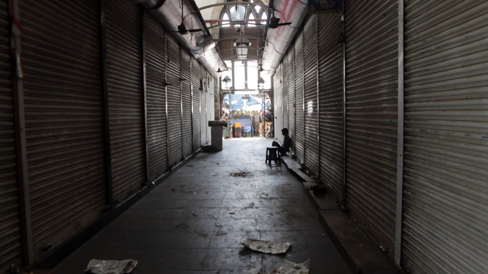 Man sits outside a closed wholesale market in Mumbai, India, . As cities and factories were closing in virus-control measures, Indian migrant workers crowded a railway station to reach their home villages Sunday, suggesting social distancing could be difficult in the world's second-most populous country. For most people, the new coronavirus causes only mild or moderate symptoms. For some it can cause more severe illnessVirus Outbreak , Mumbai, India - 24 Mar 2020
