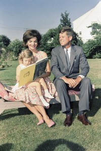 John F. Kennedy, Jacqueline, who reads to their daughter Caroline, at Hyannis Port, Mass., 1960.