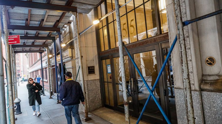 Pedestrians pass the offices of Gap Inc., in New York. Gap Inc. says that it has closed its New York office and is asking employees to work from home "until further notice" after learning that one of its employees was confirmed to have the new virus