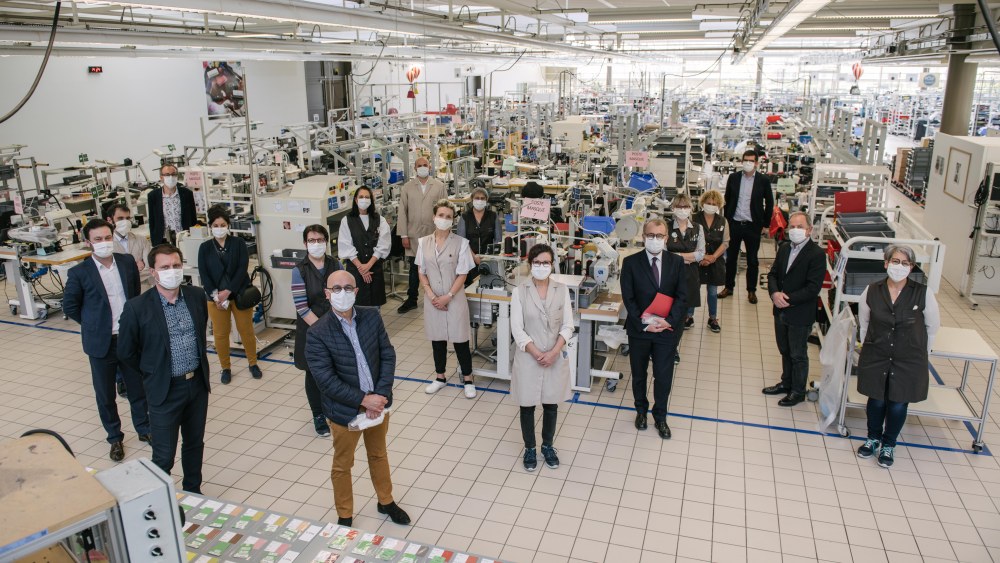 Michael Burke (second from right) poses with local officials and staff members at the Louis Vuitton atelier in Sainte-Florence.