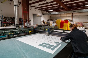 Masks are being cut. Much of the processes at OnPoint are automated.